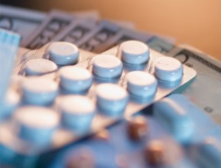 Close-up image of prescription medicine and dollar bills