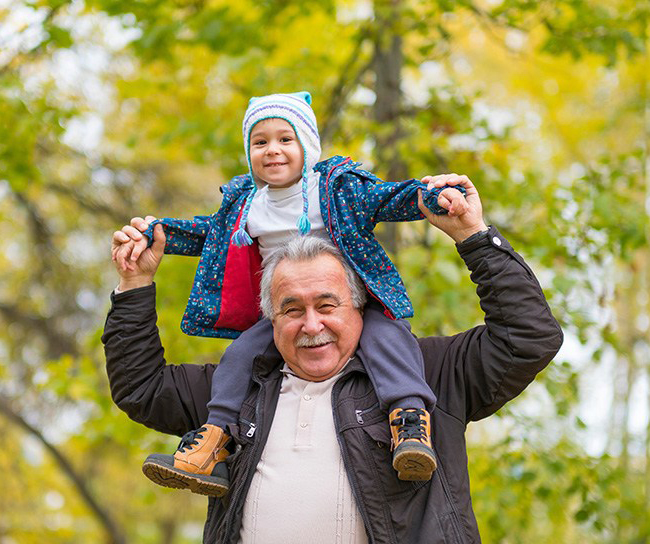 abuelo llevando a su nieto sobre los hombros
