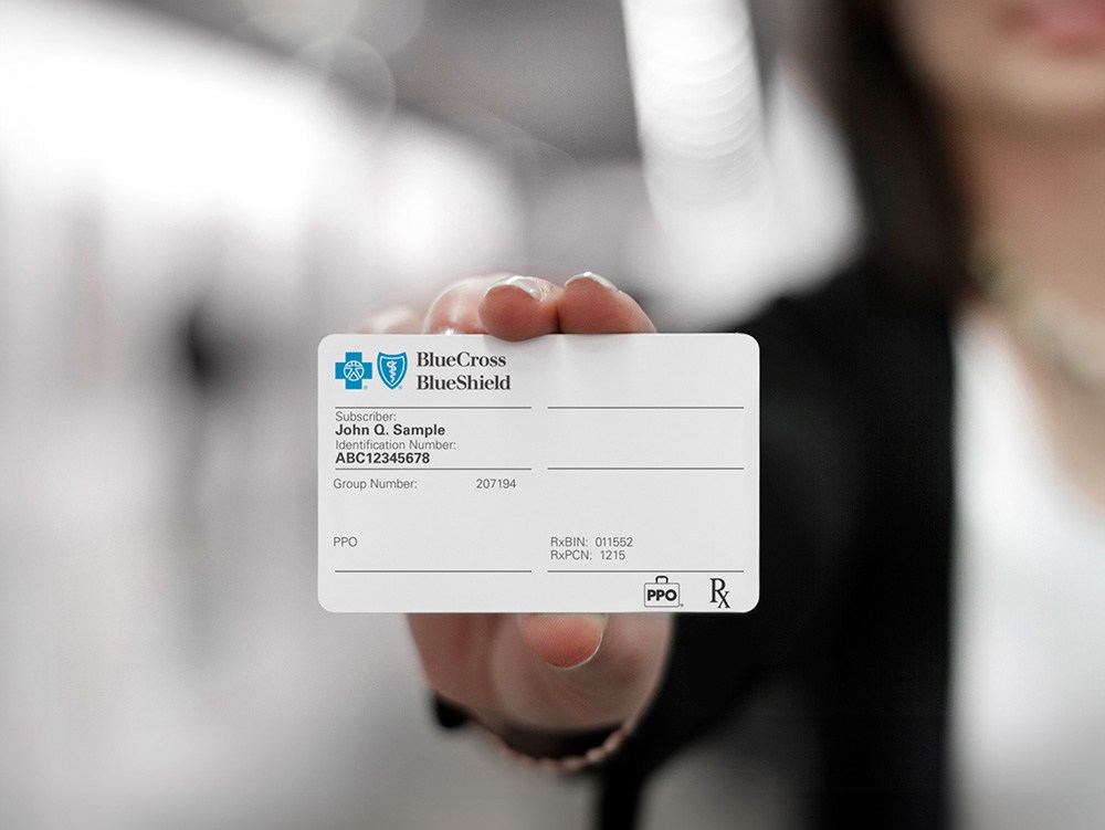 Hand holding BCBS ID card