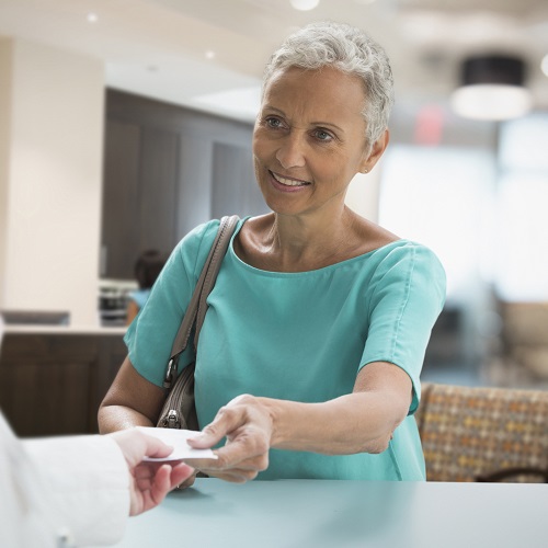 Woman getting prescription from a doctor.