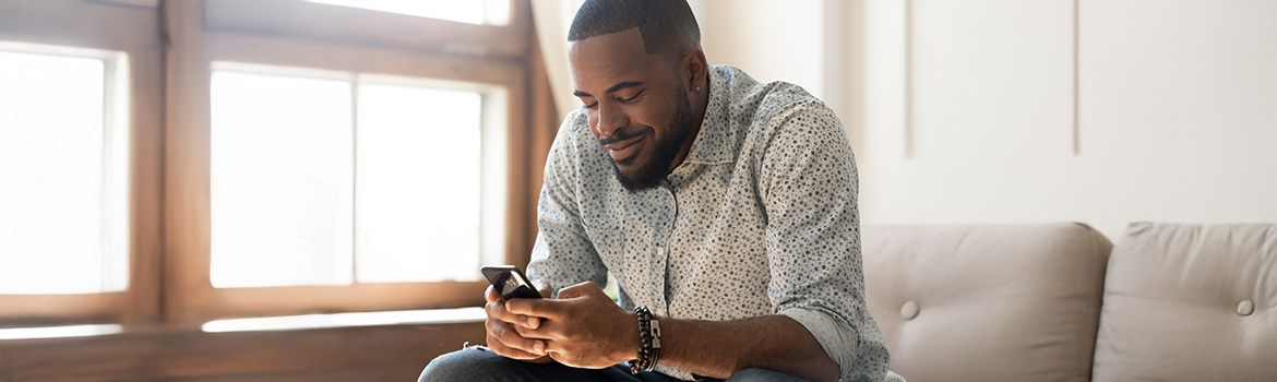 man smiling at a phone