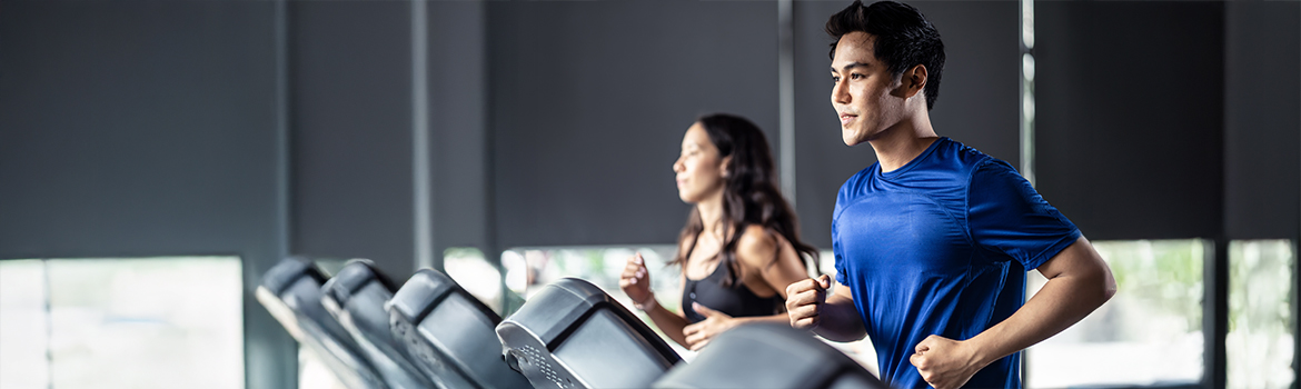 man and woman excersizing on treadmill