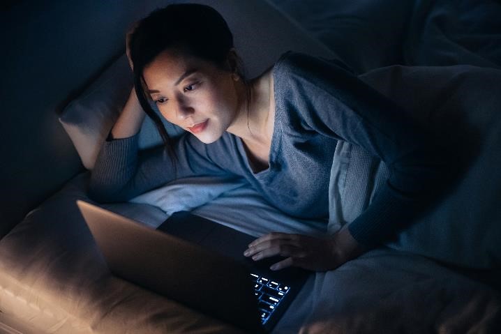 Woman on her laptop at night
