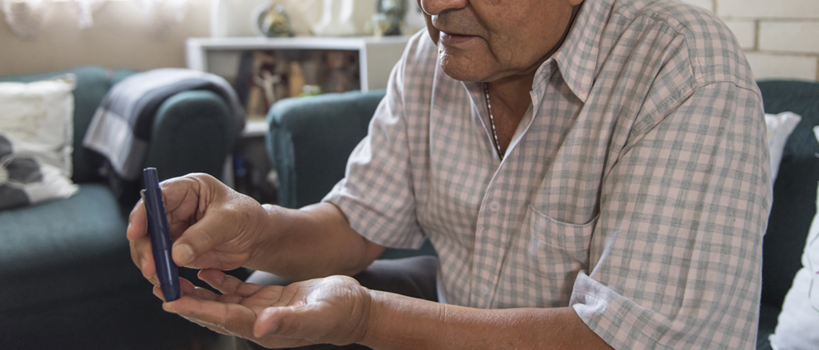 Man picks his finger to check his blood sugar level