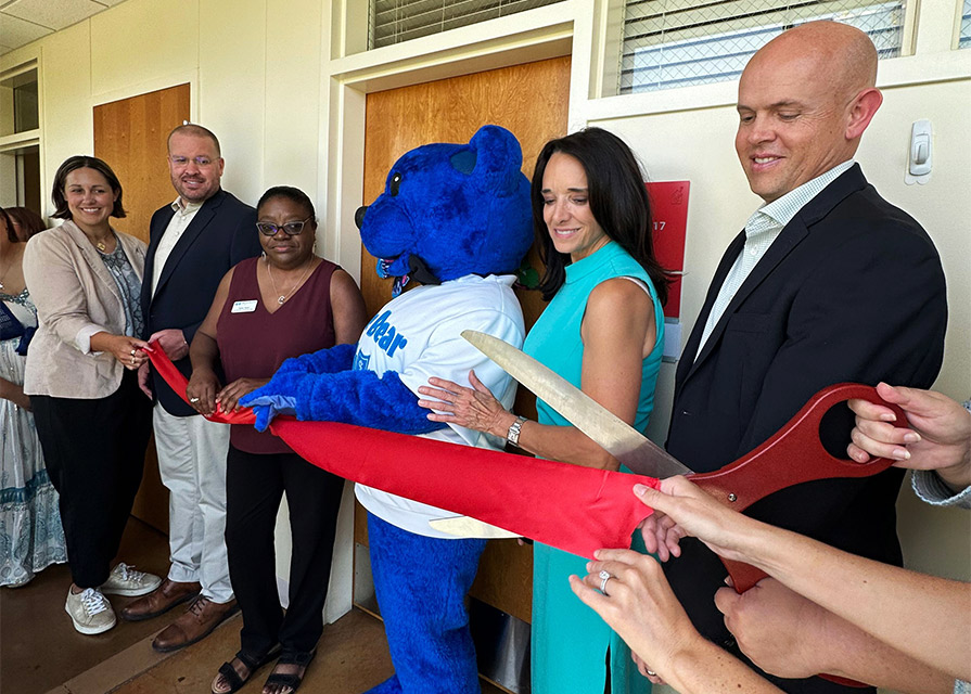 Ronald McDonal House Charities and BCBSTX employees cut ribbon for virtual library