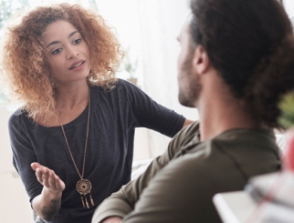 Young woman talking to a young man.