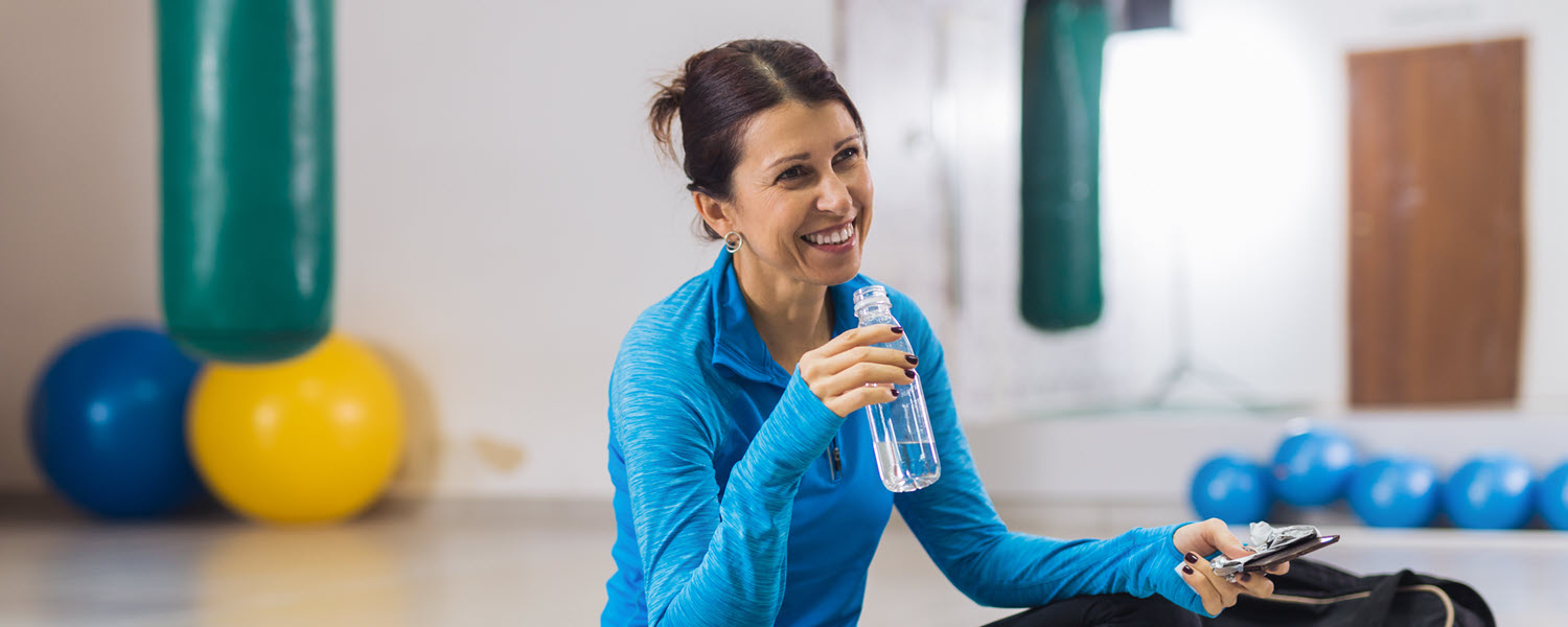 Woman in gym taking break