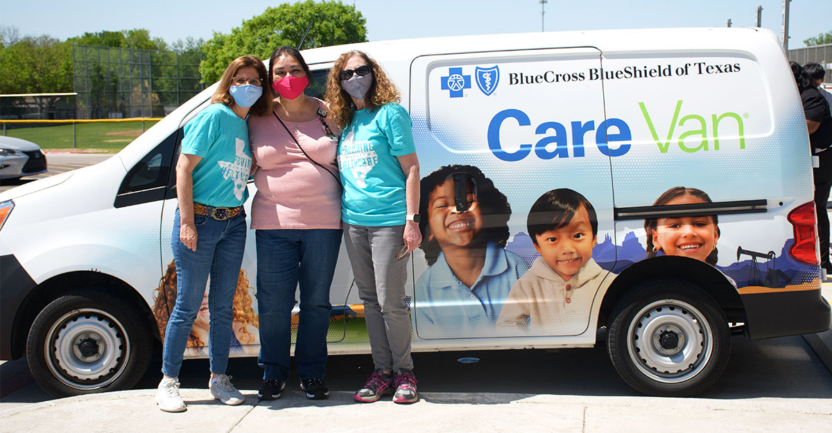 Three woman pose in front of Care Van®