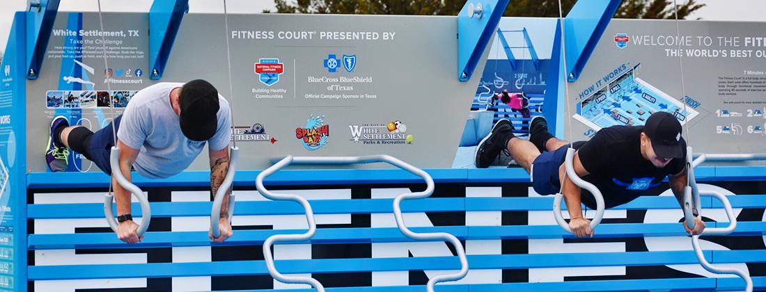 Two men using outdoor fitness court