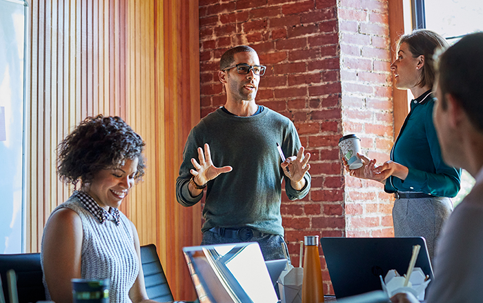 A group of diverse coworkers collaborates together in office space