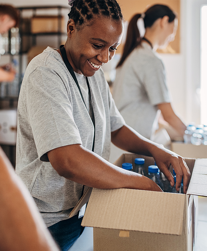 Volunteer sorts goods in donation box